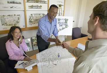 Photo of a man and woman doing business with a customer.